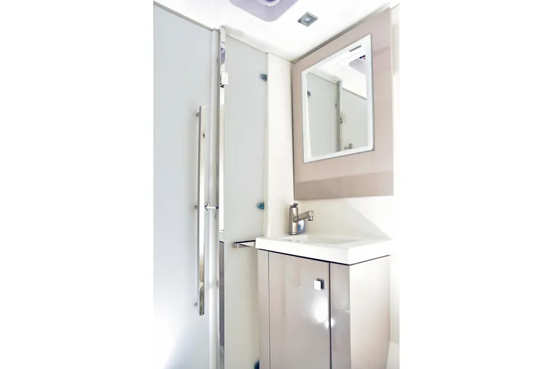Boomerang Yacht Photos Pics Modern bathroom interior of 2022 Fountaine Pajot Astrea 42 yacht, featuring sleek sink and mirror.