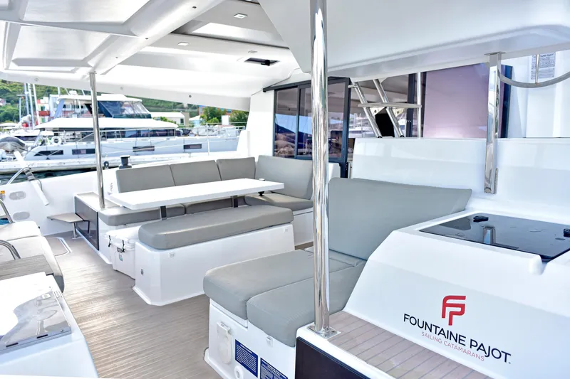 Boomerang Yacht Photos Pics Luxurious 2022 Fountaine Pajot Astrea 42 catamaran interior with modern seating and dining area.