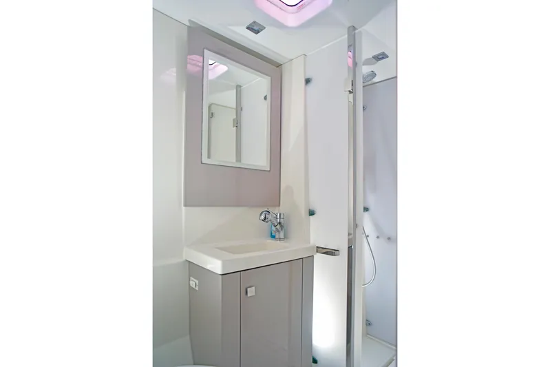 Boomerang Yacht Photos Pics Modern bathroom in 2022 Fountaine Pajot Astrea 42 yacht, featuring sleek sink and shower.