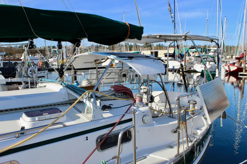 Mangata Yacht Photos Pics Sailboat Valiant 39, 1997 model, docked in a marina with solar panel and equipment.