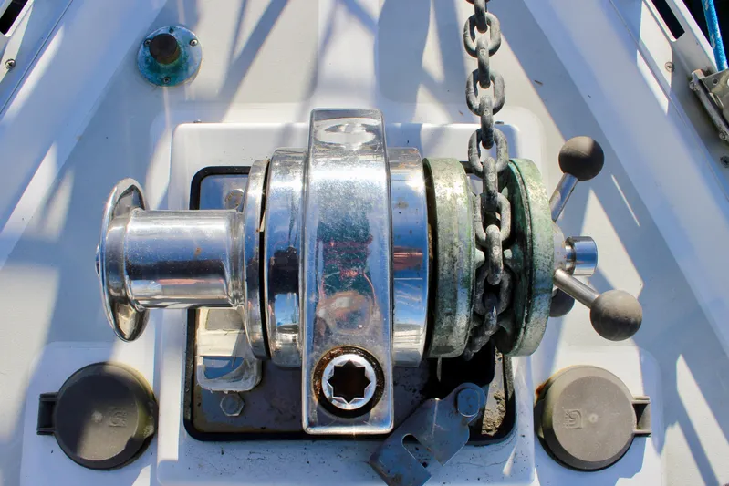 Mangata Yacht Photos Pics Anchor windlass on a 1997 Valiant 39 sailboat deck, featuring chain and controls.