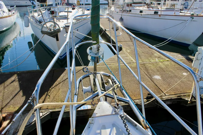 Mangata Yacht Photos Pics Sailboat docked at marina, Valiant 39, 1997 model, surrounded by calm water.