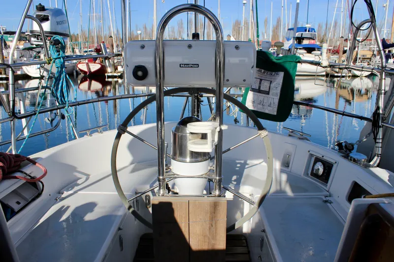 Mangata Yacht Photos Pics Cockpit of a 1997 Valiant 39 sailboat in a marina, featuring steering wheel and equipment.