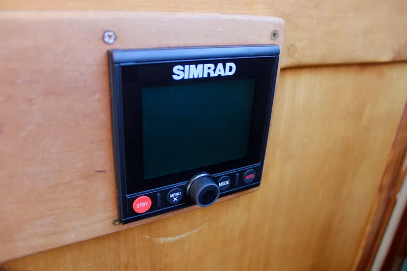 Mangata Yacht Photos Pics Simrad control panel on 1997 Valiant 39 boat, mounted on wooden surface.