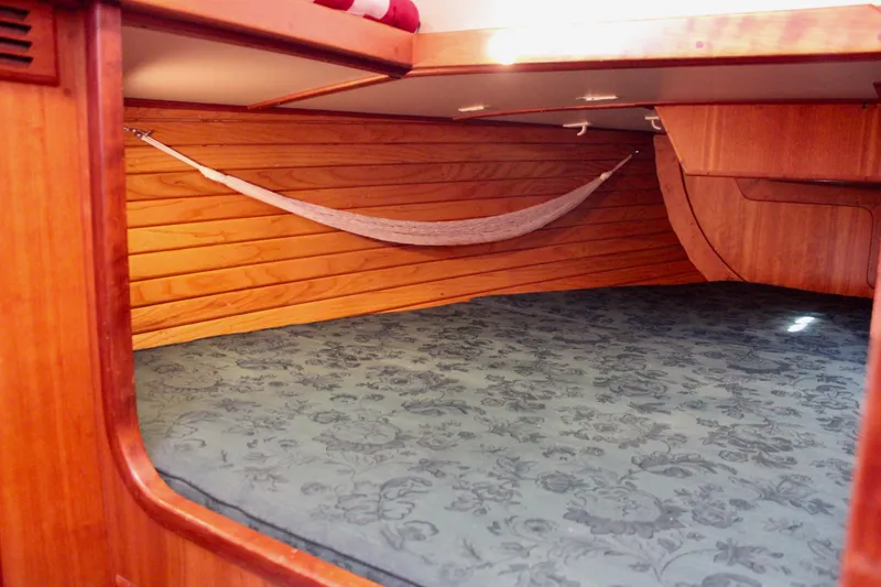 Mangata Yacht Photos Pics 1997 Valiant 39 yacht interior with wooden paneling and a cozy sleeping area.