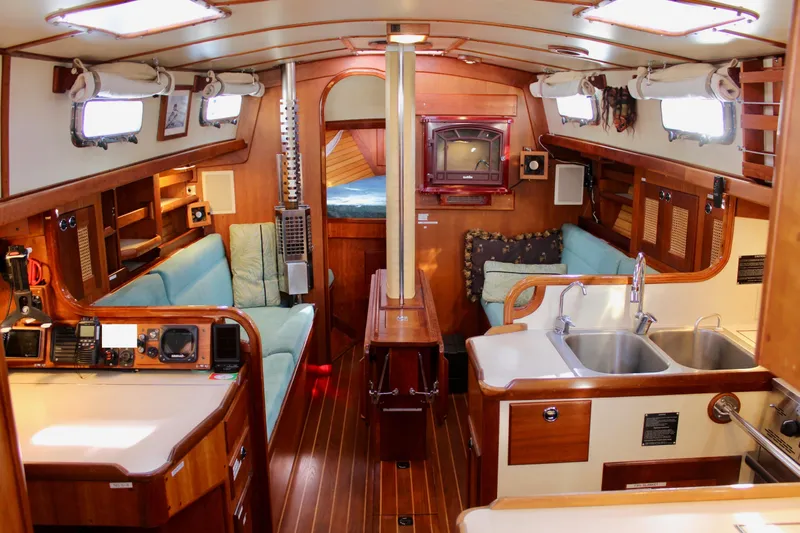 Mangata Yacht Photos Pics Interior of a 1997 Valiant 39 sailboat with wood finishes and cozy seating.