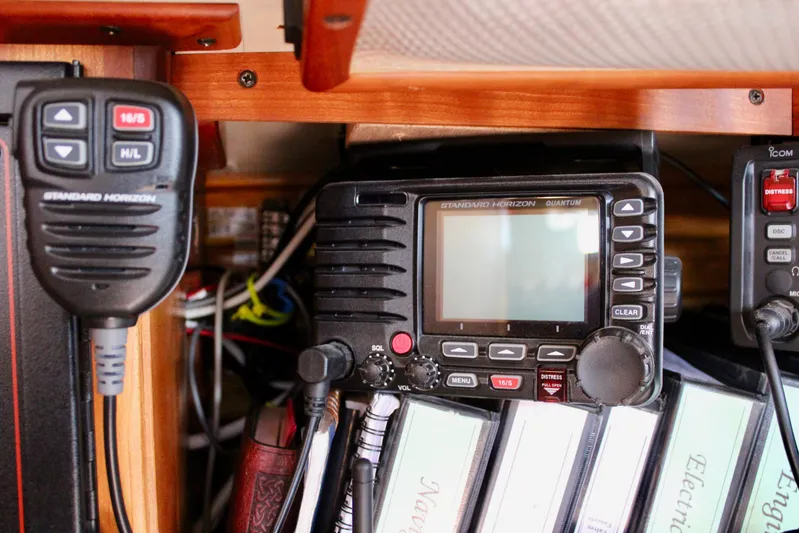 Mangata Yacht Photos Pics Radio equipment and manuals inside a 1997 Valiant 39 sailboat cabin.