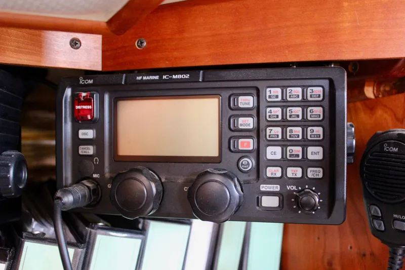 Mangata Yacht Photos Pics ICOM marine radio on 1997 Valiant 39 sailboat, featuring distress button and microphone.