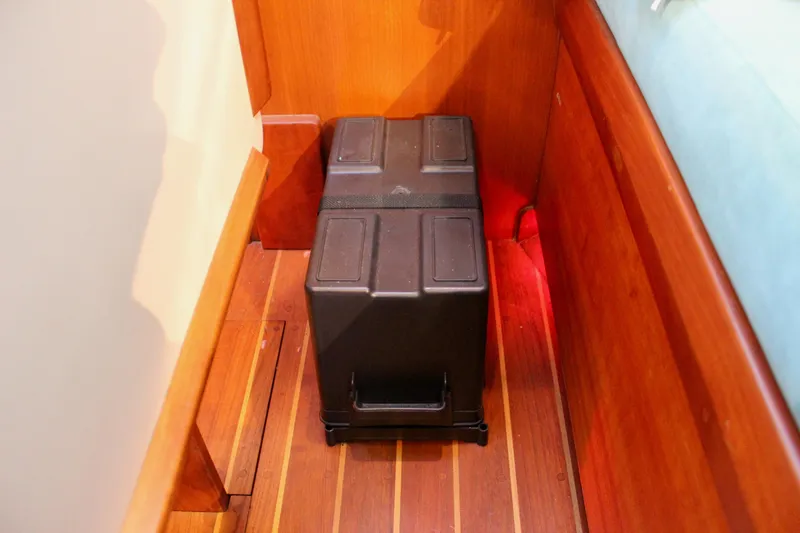 Mangata Yacht Photos Pics Battery box on wooden floor of 1997 Valiant 39 boat interior.