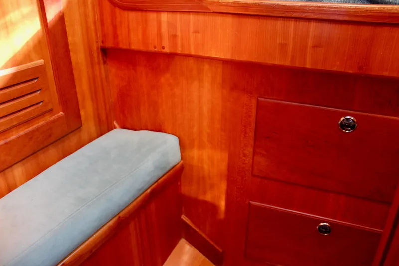 Mangata Yacht Photos Pics Interior of 1997 Valiant 39 sailboat with wooden cabinetry and cushioned seating.