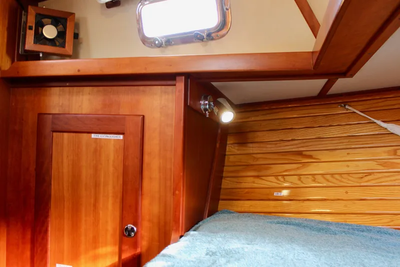 Mangata Yacht Photos Pics 1997 Valiant 39 yacht interior with wooden paneling and cozy cabin lighting.