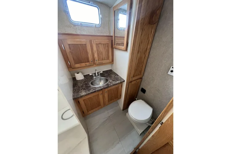  Yacht Photos Pics Bathroom interior of 2006 Provincial 42 Lobster Boat with wooden cabinets and compact design.