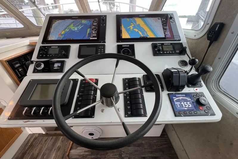  Yacht Photos Pics Control panel of a 2006 Provincial 42 Lobster Boat with navigation screens and steering wheel.