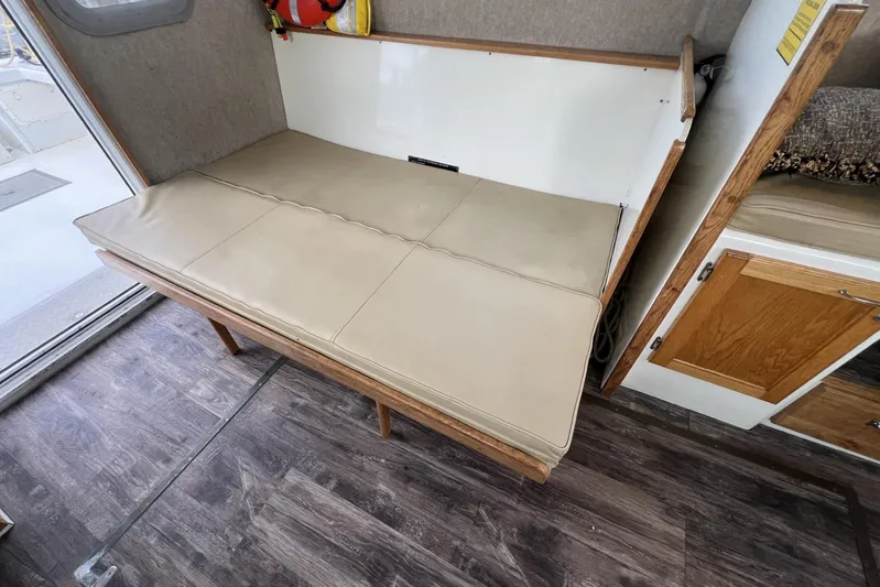  Yacht Photos Pics Interior of 2006 Provincial 42 Lobster Boat with beige cushioned seating and wooden flooring.