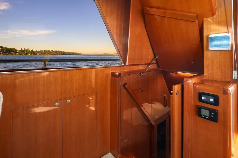 La Bella Vita II Yacht Photos Pics Interior of 2014 Hampton 720 Skylounge LRC yacht with wooden finish and ocean view.