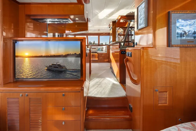 La Bella Vita II Yacht Photos Pics Luxurious interior of 2014 Hampton 720 Skylounge LRC yacht with wood finishes and TV display.