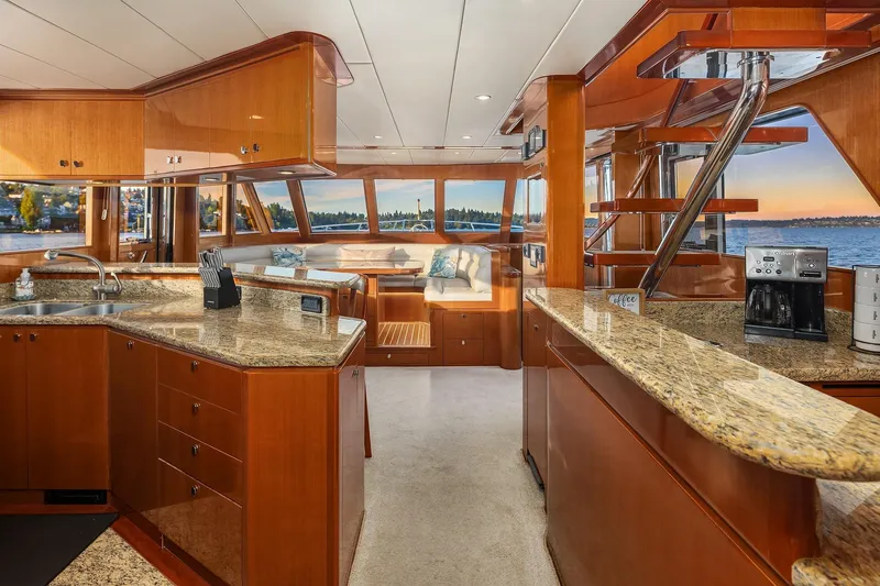 La Bella Vita II Yacht Photos Pics Luxurious interior of 2014 Hampton 720 Skylounge LRC yacht with elegant wood finishes and granite countertops.