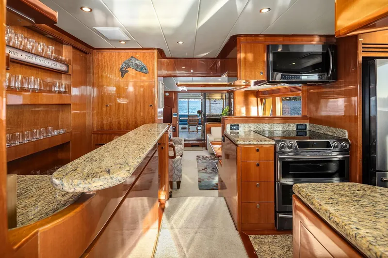 La Bella Vita II Yacht Photos Pics Luxurious interior of 2014 Hampton 720 Skylounge LRC yacht with elegant wood and granite finishes.