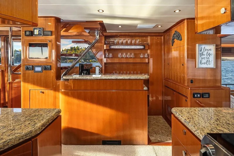 La Bella Vita II Yacht Photos Pics Luxurious interior of 2014 Hampton 720 Skylounge LRC yacht with elegant wood finishes.