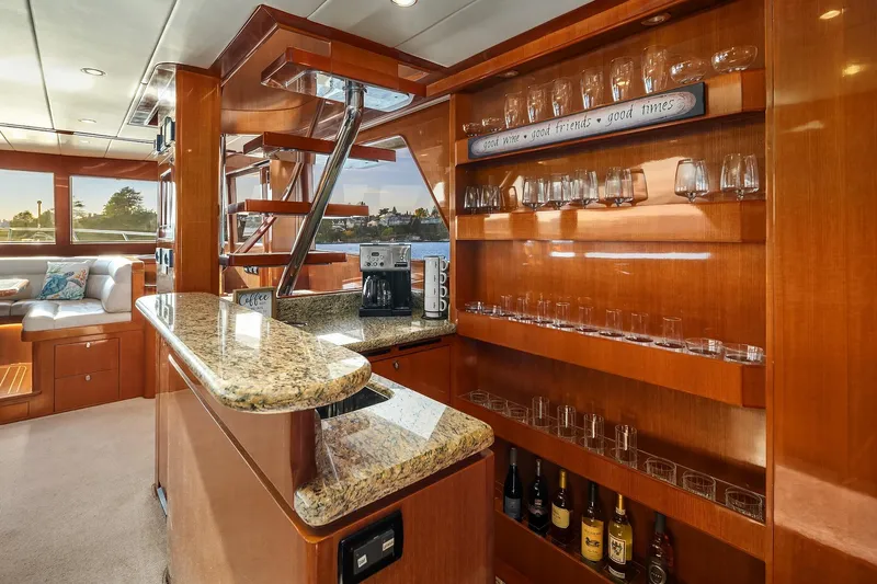 La Bella Vita II Yacht Photos Pics Luxurious bar area in 2014 Hampton 720 Skylounge LRC yacht with granite countertop and glassware.