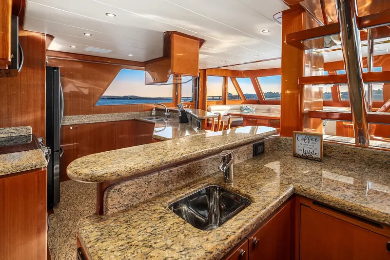 La Bella Vita II Yacht Photos Pics Luxurious 2014 Hampton 720 Skylounge LRC yacht interior with granite countertops and ocean view.