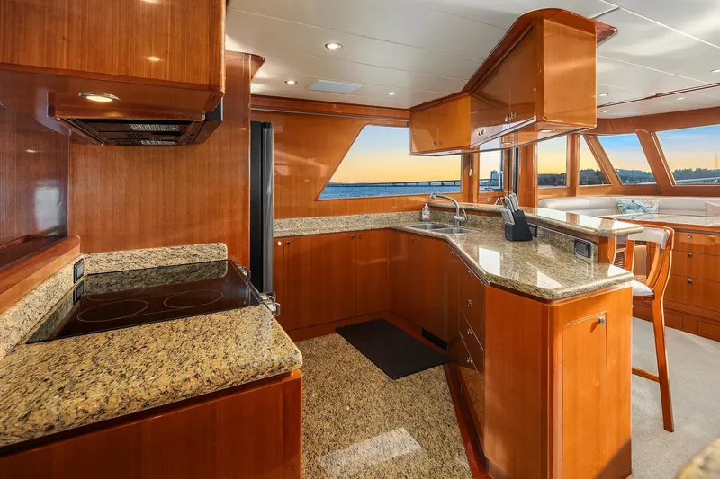 La Bella Vita II Yacht Photos Pics Luxurious kitchen interior of 2014 Hampton 720 Skylounge LRC yacht with granite countertops.