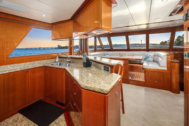 La Bella Vita II Yacht Photos Pics Luxurious interior of 2014 Hampton 720 Skylounge LRC yacht with elegant wood finishes and ocean view.