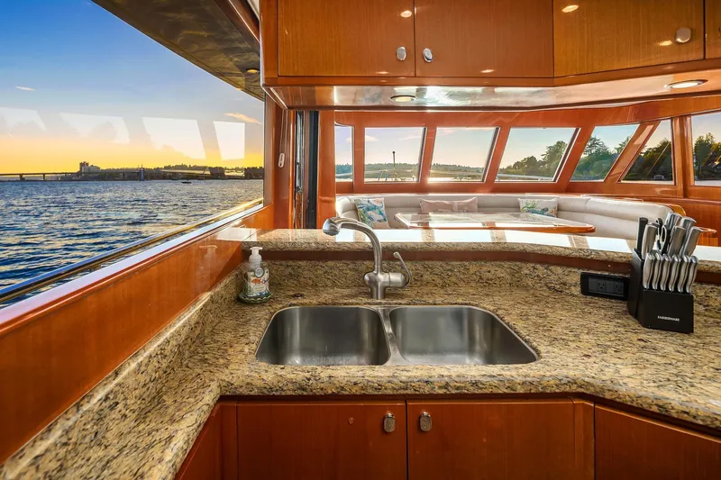 La Bella Vita II Yacht Photos Pics Luxurious 2014 Hampton 720 Skylounge LRC yacht interior with granite countertops and scenic water views.
