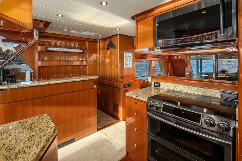 La Bella Vita II Yacht Photos Pics Luxurious 2014 Hampton 720 Skylounge LRC yacht kitchen with granite countertops and modern appliances.