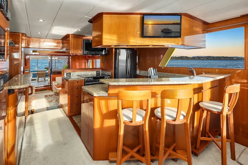 La Bella Vita II Yacht Photos Pics Luxurious interior of 2014 Hampton 720 Skylounge LRC yacht with elegant wood finishes and ocean view.