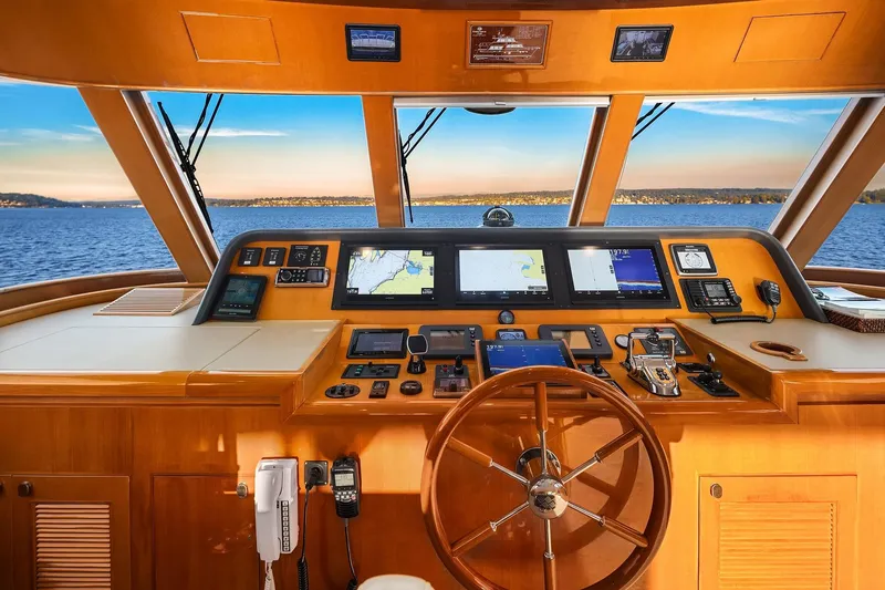 La Bella Vita II Yacht Photos Pics Helm of 2014 Hampton 720 Skylounge LRC yacht with navigation screens and wooden steering wheel.