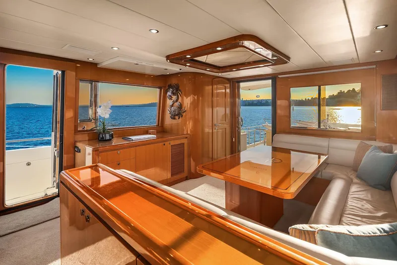 La Bella Vita II Yacht Photos Pics Luxurious interior of 2014 Hampton 720 Skylounge LRC yacht with ocean view at sunset.