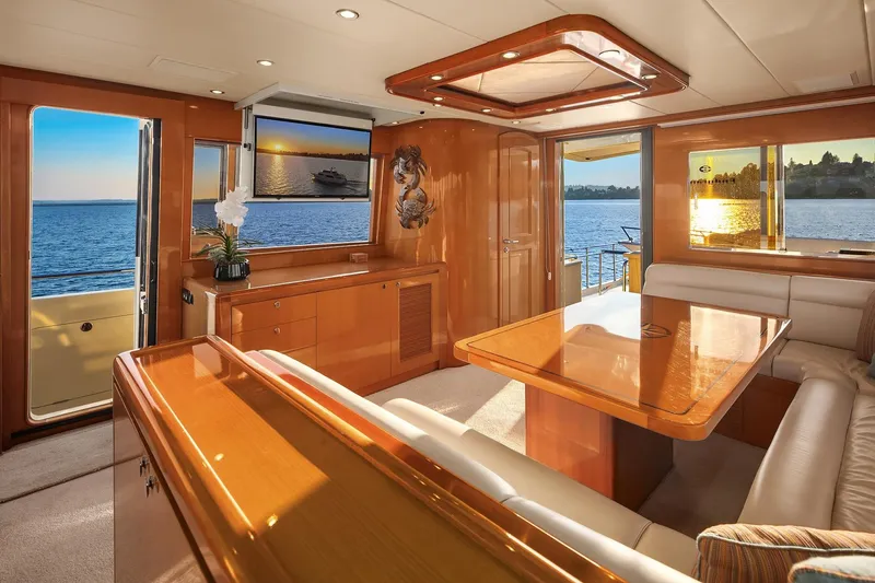 La Bella Vita II Yacht Photos Pics Luxurious interior of 2014 Hampton 720 Skylounge LRC yacht with elegant wood finishes and scenic ocean view.