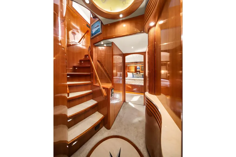La Bella Vita II Yacht Photos Pics Luxurious interior of 2014 Hampton 720 Skylounge LRC yacht with polished wood and elegant staircase.