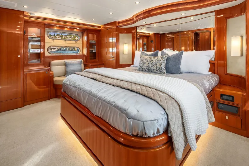 La Bella Vita II Yacht Photos Pics Luxurious bedroom interior of 2014 Hampton 720 Skylounge LRC yacht with elegant wood finishes.