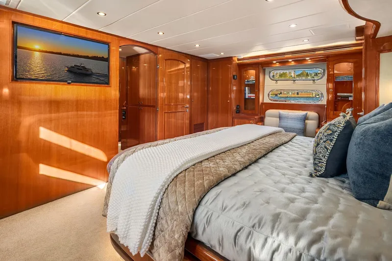 La Bella Vita II Yacht Photos Pics Luxurious bedroom interior of 2014 Hampton 720 Skylounge LRC yacht with elegant wood finishes.