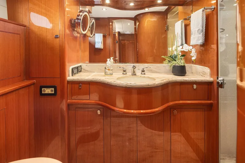 La Bella Vita II Yacht Photos Pics Luxurious bathroom in 2014 Hampton 720 Skylounge LRC yacht with elegant wood finish.