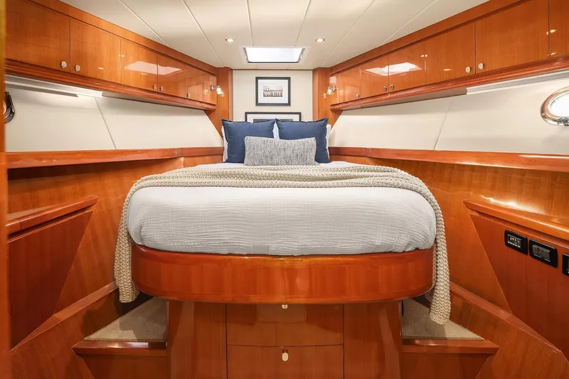 La Bella Vita II Yacht Photos Pics Luxurious bedroom interior of 2014 Hampton 720 Skylounge LRC yacht with wood finish.