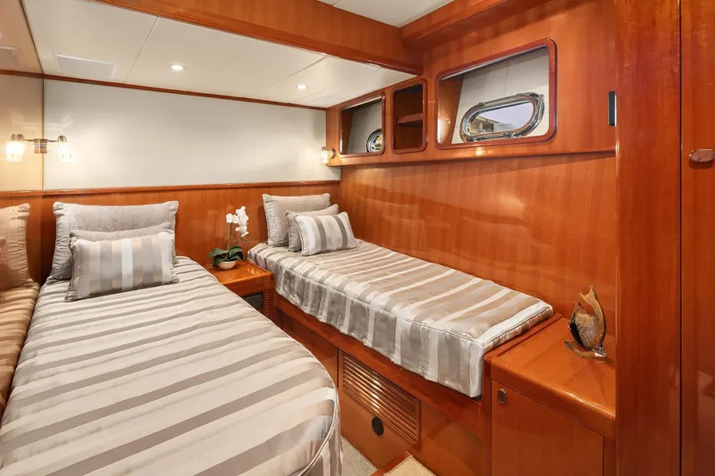 La Bella Vita II Yacht Photos Pics Luxurious twin cabin in 2014 Hampton 720 Skylounge LRC yacht, featuring elegant wood finishes.