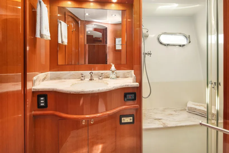 La Bella Vita II Yacht Photos Pics Luxurious bathroom in 2014 Hampton 720 Skylounge LRC yacht with marble countertop and shower.