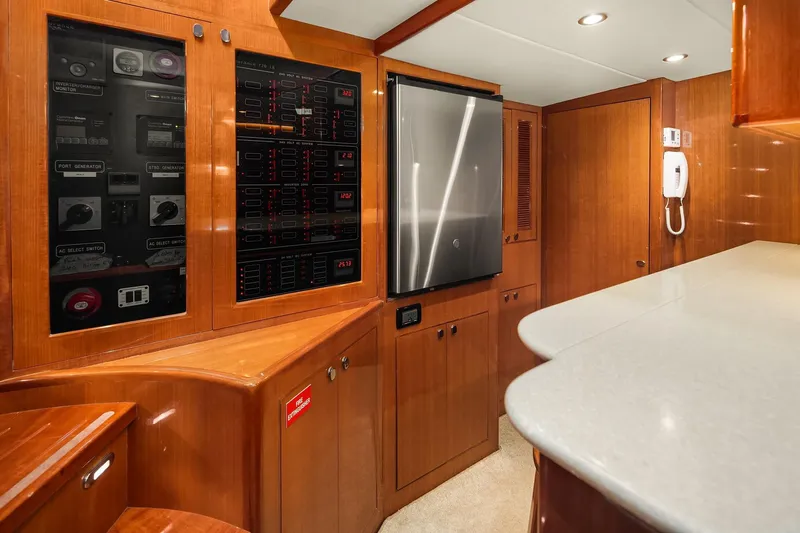 La Bella Vita II Yacht Photos Pics Interior of 2014 Hampton 720 Skylounge LRC yacht with control panels and modern cabinetry.