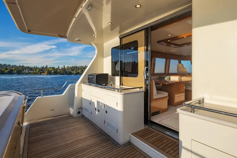 La Bella Vita II Yacht Photos Pics Luxurious 2014 Hampton 720 Skylounge LRC yacht deck with scenic water view.
