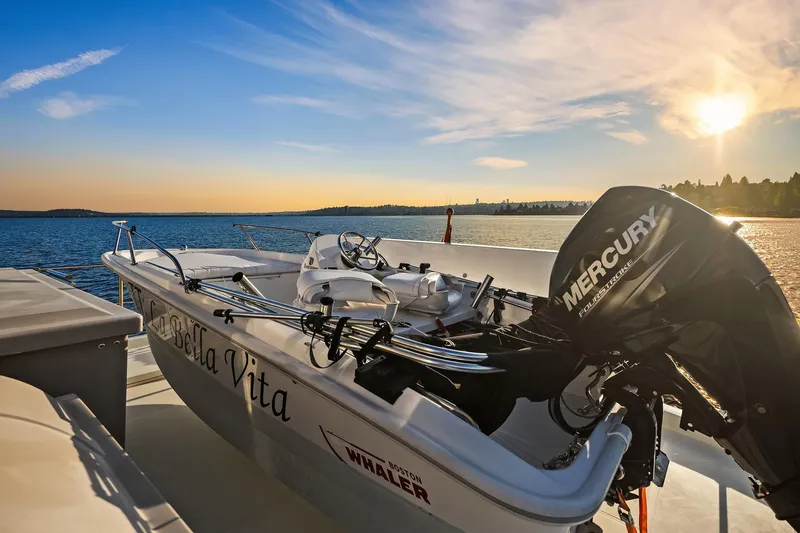 La Bella Vita II Yacht Photos Pics 2014 Hampton 720 Skylounge LRC yacht with Mercury engine at sunset on serene water.
