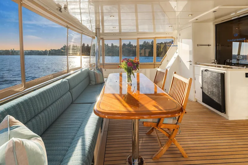 La Bella Vita II Yacht Photos Pics Luxurious 2014 Hampton 720 Skylounge LRC yacht interior with elegant dining area and scenic water view.