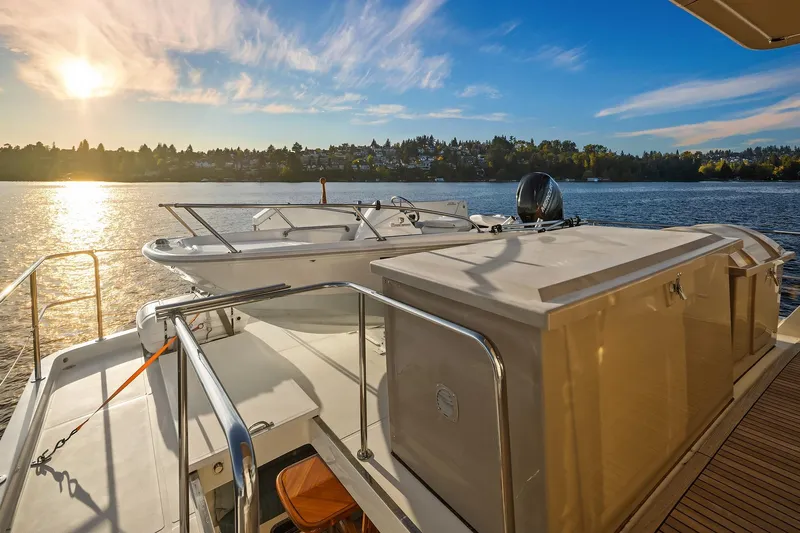 La Bella Vita II Yacht Photos Pics 2014 Hampton 720 Skylounge LRC yacht at sunset on serene water.