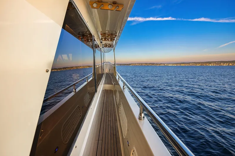 La Bella Vita II Yacht Photos Pics Side deck view of 2014 Hampton 720 Skylounge LRC yacht cruising on open water.