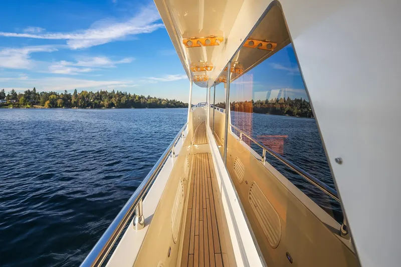 La Bella Vita II Yacht Photos Pics 2014 Hampton 720 Skylounge LRC yacht cruising on a serene lake under a clear blue sky.