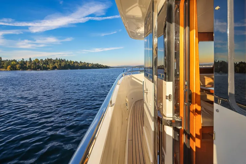 La Bella Vita II Yacht Photos Pics Luxurious 2014 Hampton 720 Skylounge LRC yacht cruising on serene waters at sunset.