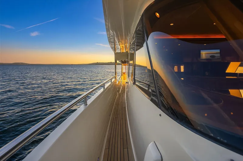 La Bella Vita II Yacht Photos Pics 2014 Hampton 720 Skylounge LRC yacht cruising at sunset on open water.
