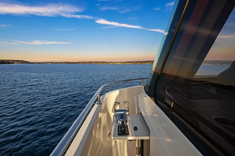 La Bella Vita II Yacht Photos Pics 2014 Hampton 720 Skylounge LRC yacht cruising on serene blue waters at sunset.